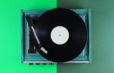 Retro vinyl record player on green backgroundの写真素材