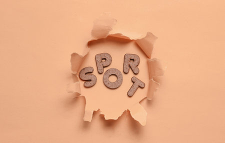 The word sport in a torn hole of orange pastel background. Minimalistic sport background
