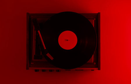Retro vinyl record player. Red neon light, top view