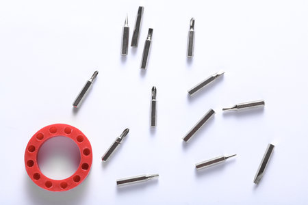 Set of metal screwdriver bits on white background