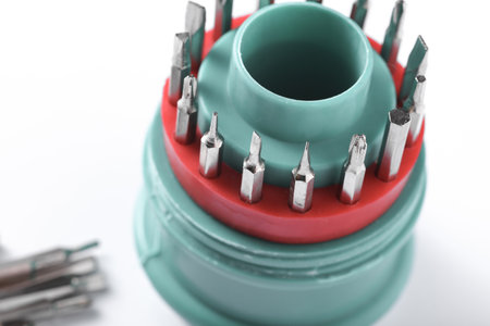 Set of metal screwdriver bits on white background