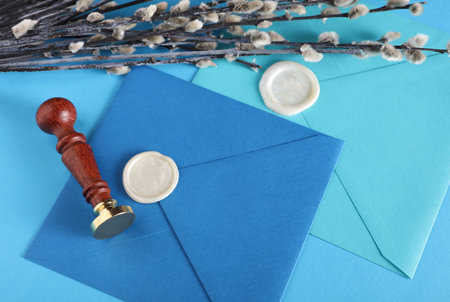 Envelopes with wax seals and vintage stamp, willow branches on blue background. Gift certificate, wedding invitationの写真素材
