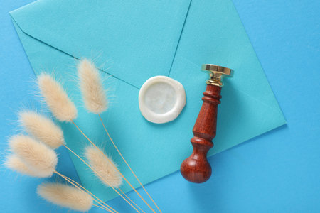 Envelopes with wax seals and vintage stamp, lagurus flowers on blue background. Gift certificate, wedding invitationの写真素材