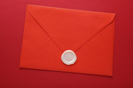 Envelopes with wax seals on red background. Gift certificate, wedding invitationの写真素材