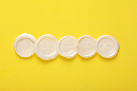 Mockup of white wax seals on yellow background