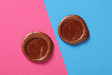 Brown wax seals on pink blue background