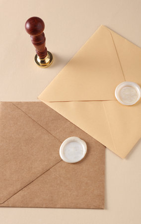 Envelopes with wax seals and vintage stamp, willow branches on beige background. Gift certificate, wedding invitationの写真素材