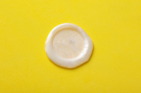 Mockup of white wax seal on yellow background
