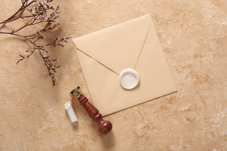 Envelope with wax seal and vintage stamp, dry flowers on concrete background. Gift certificate,...