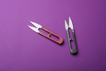 Scissors on purple backgroundの写真素材