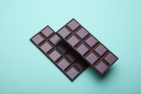 Dark chocolate bars on a blue background