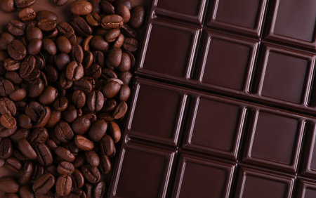 Chocolate bar and coffee beans on white background, top view.