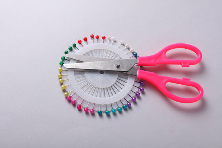 Set of sewing pins with scissors on a gray backgroundの写真素材