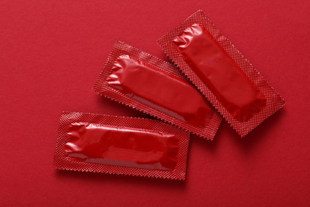 Condom packages on a red backgroundの写真素材