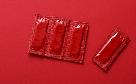 Condom packages on a red backgroundの写真素材