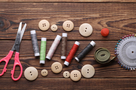 Tailor sewing accessories on wooden background.の写真素材