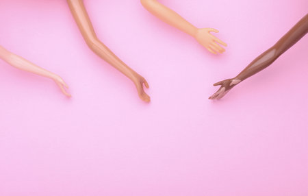 Many different dolls hands on pink background. Social support, friendshipの写真素材