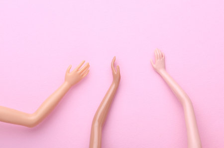 Many different dolls hands on pink background. Social support, friendshipの写真素材