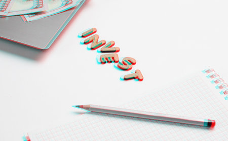 Creative business concept. Laptop, notebook, pencil, dollar bills on white background with the word invest of wooden letters, minimalism. Glitch effectの写真素材