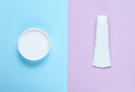 Minimalistic oral hygiene concept. Tube of toothpaste, tooth powder on a pastel background. Teeth...