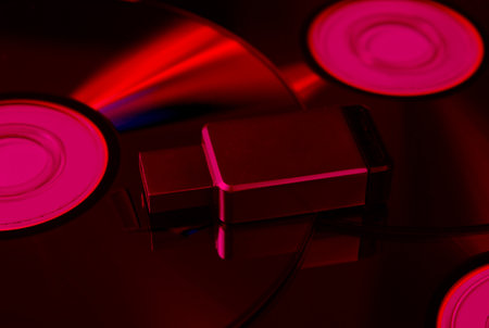 USB flash drive on CDs. Pink neon lightの写真素材