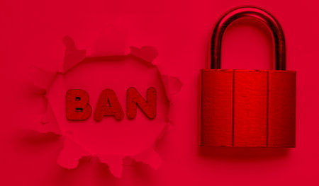 Lock and the word ban in torn hole. Red neon lightの写真素材