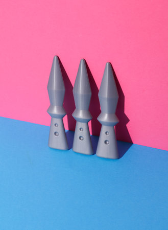 Toy ninja throwing weapons on pink blue backgroundの写真素材