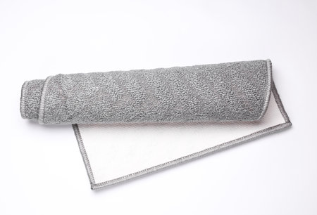 Roll of gray anti slip mat or carpet on white backgroundの写真素材