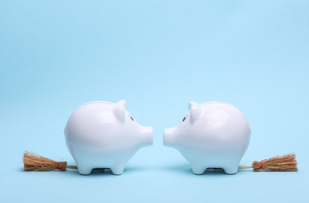 Piggy banks with Halloween decor on a blue backgroundの写真素材