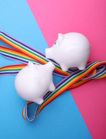 Ceramic white piggy bank with rainbow ribbonの写真素材