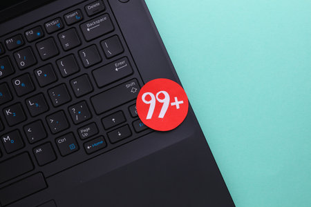 Laptop with notification icon on blue background