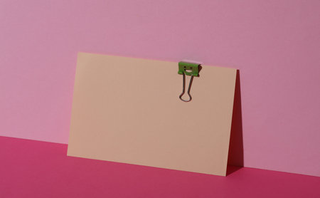 Binder clip with a smiling face on card. Business conceptの写真素材