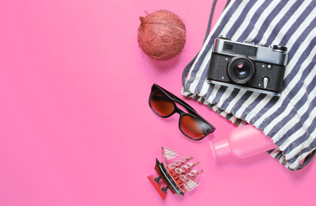 Beach vacation accessories on pink background. Summer creative background. Top view. Copy spaceの写真素材