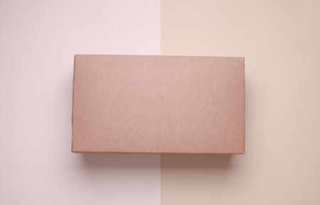 Cardboard shoe box on beige backgroundの写真素材