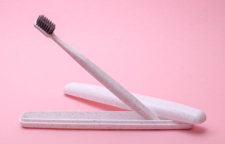 Case with Toothbrush floating on pink backgroundの写真素材