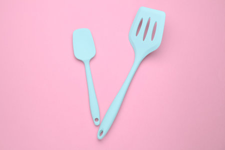 Silicone kitchen spatulas on pink backgroundの写真素材