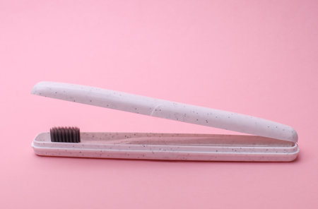 Case with Toothbrush floating on pink backgroundの写真素材