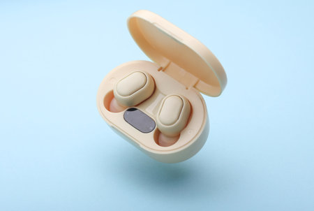Wireless Earphones with Charging Case Floating on blue Background