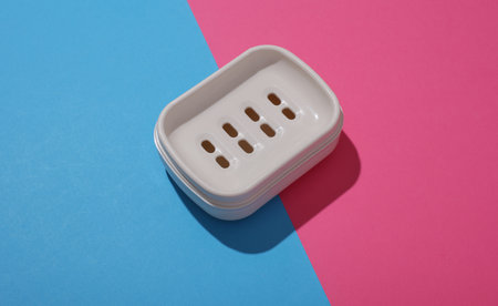 Plastic Soap Dish on Blue Pink Backgroundの写真素材