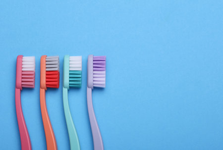 Set of plastic toothbrushes on a blue backgroundの写真素材