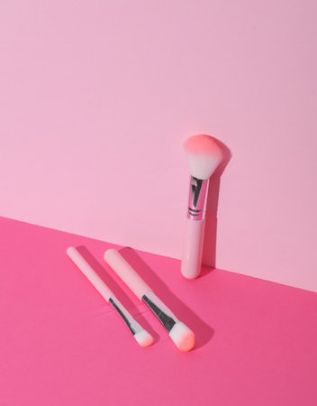 Makeup brushes on pink background. Creative layout. Beauty conceptの写真素材