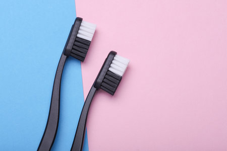 Plastic toothbrushes on blue pink backgroundの写真素材