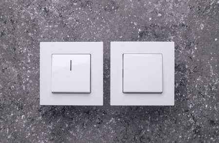 Two Light Switches on a Gray Concrete Backgroundの写真素材