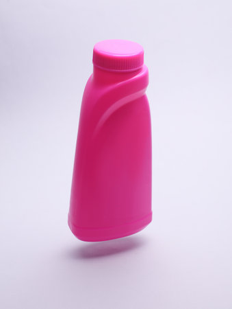 Bottle of washing gel floating on white background