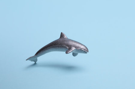 Toy plastic shark swimming on blue backgroundの写真素材