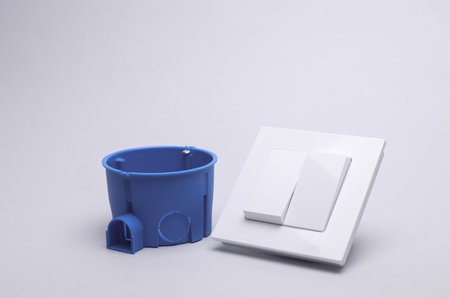 Light switch and wall box on a gray background
