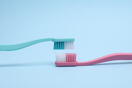 Plastic toothbrushes on blue background. Dental careの写真素材