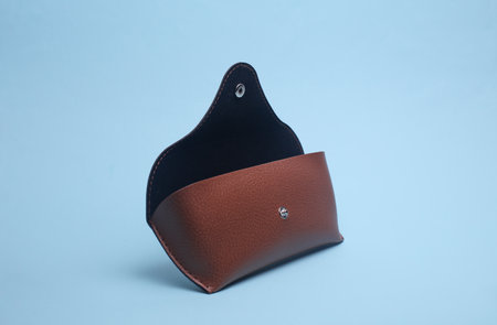 Leather glasses case on blue backgroundの写真素材