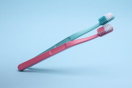 Plastic toothbrushes floating on blue background. Dental careの写真素材