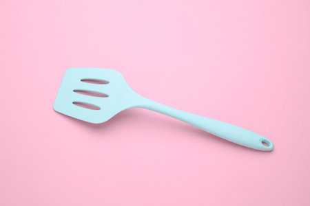 Silicone kitchen spatula on a pink backgroundの写真素材
